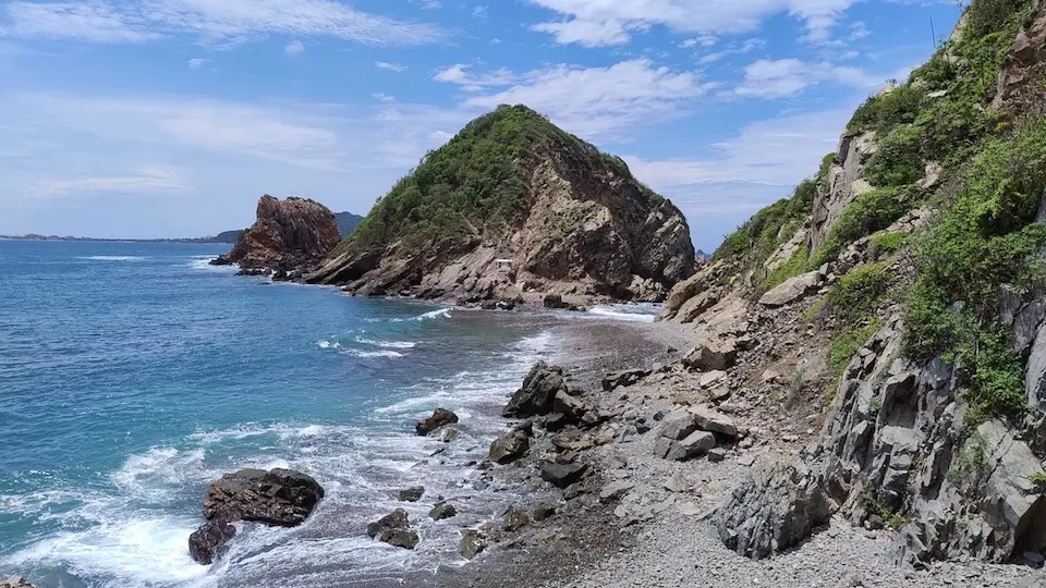 The bay of Barra de Navidad in Jalisco is surrounded by rocks and small mountains.